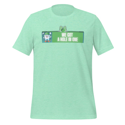 Cute dentist t-shirt showcasing an adorable tooth character in golf attire, joyfully celebrating a ‘hole in one’ achievement, perfect for dentist and dental professionals seeking unique and thematic dental apparel. Heather mint color, front view.