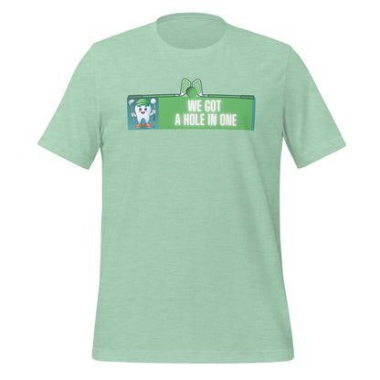 Cute dentist t-shirt showcasing an adorable tooth character in golf attire, joyfully celebrating a ‘hole in one’ achievement, perfect for dentist and dental professionals seeking unique and thematic dental apparel. Heather prism mint color, front view.